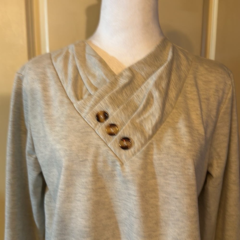 Tan long sleeve blouse 3 button accent on front
Gathered around V neck